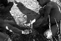 Small children playing a kaio game with munika seeds