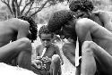 Men working on mikaks (neck ornaments)