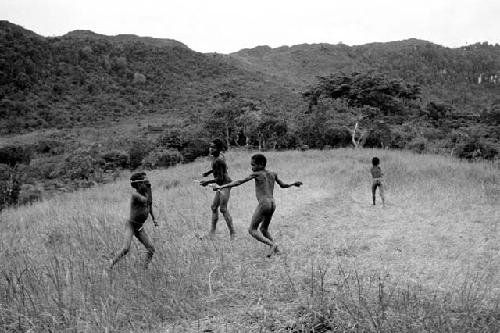 Four boys playing weem yelé on the Anelerak; view to the east