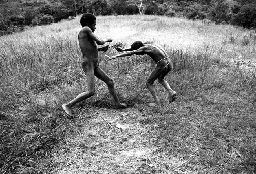 Two boys playing weem yele on the Anelerak