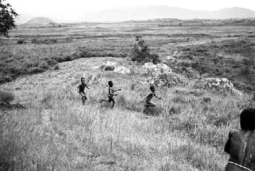 Three boys running on the Anelerak; view towards the Siobara