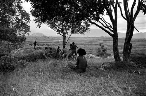 Boys playing under a munika tree on the Anelerak; Siobara visible in background