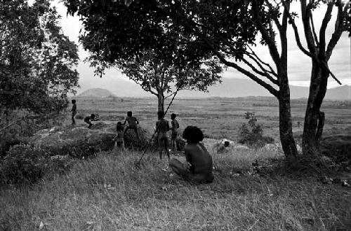 Boys playing under a munika tree on the Anelerak; Siobara visible in background