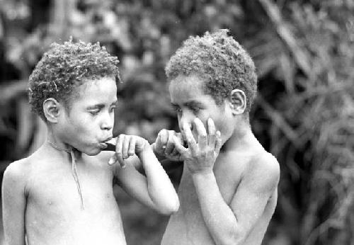 Children popping their fingers in their mouths