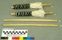 Pair of corn tassels (A & B) and pair of wooden dowels (C & D)