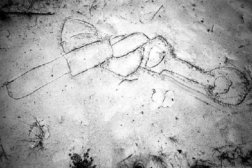 A drawing done with a stick in the sand