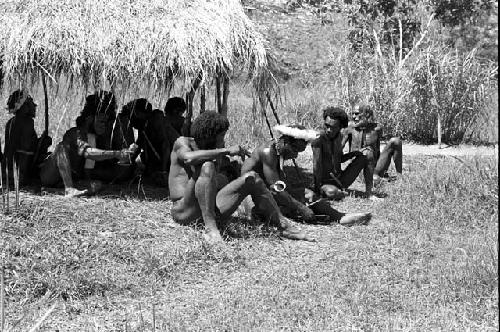 Men sitting under an oléa looking out; Weaklekek; Tegé Warek and Yege Asuk