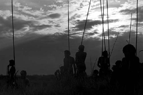 Silhouettes of warriors watching a battle