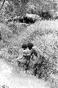 Men washing in an irrigation ditch