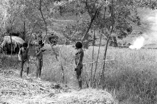 Men about to go to work; garden shelter behind