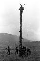 A man standing on top of a kaio near the Tokolik, men standing below