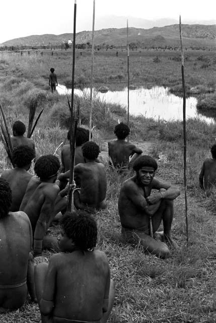 Men sitting by a pond on the Tokolik