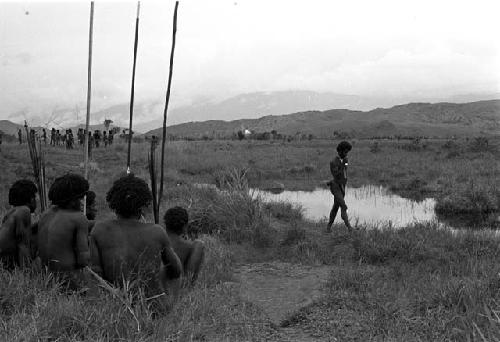 Men sitting by a pond on the Tokolik