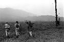 Robert Gardner, Karl Heider, and Peter Matthiessen, and others return home in the rain after a battle