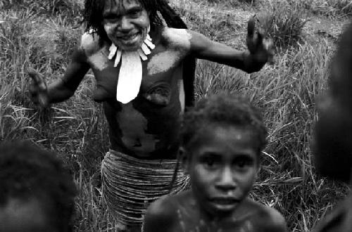 A woman and children look at the camera at an Etai