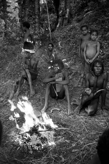 People grouped around the fire outside Robert Gardner's tent