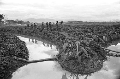 Warriors on a path near irrigation ditches