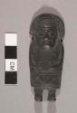 Small solid copper human figure with fan-shaped headdress