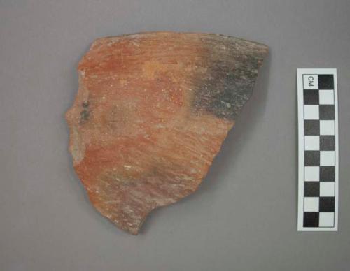 Ceramic rim sherd of bowl, rim edge is flat, burnished