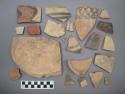 Ceramic body or rim sherds and a base sherd and a plate? sherd, some with pigment