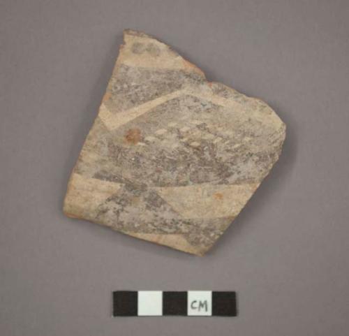 Ceramic body sherd, black painted designs on buff on exterior