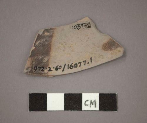 Ceramic body sherd with brown pigment on interior side