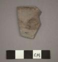 Ceramic rim sherd of bowl, brown painted design on exterior