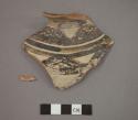 Ceramic rim sherd of jar, black designs on buff exterior