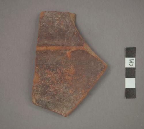 Ceramic body sherd, red pigment and ridged design on exterior