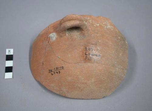 Fragment of plain orange pottery bowl