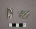 Ceramic body sherds with black designs on white exterior