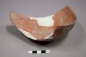 Fragments of plain orange pottery bowl--restorable?