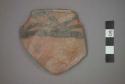 Ceramic rim sherd of bowl, black painted designs on exterior on red