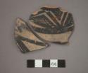 Ceramic body sherds of jar, black painted designs on white on exterior, will mend together