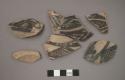 Ceramic body and base sherds, black designs on white on exterior, two sherds will mend