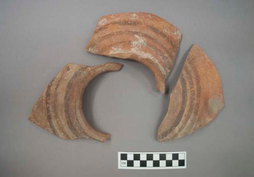 Ceramic flared rim and body sherds, three black parallel bands on shoulder, will mend together