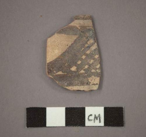 Ceramic rim sherd with black designs on buff on exterior