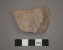 Ceramic base sherd with line of black pigment along bottom edge