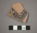 Ceramic base sherd, black painted design on interior