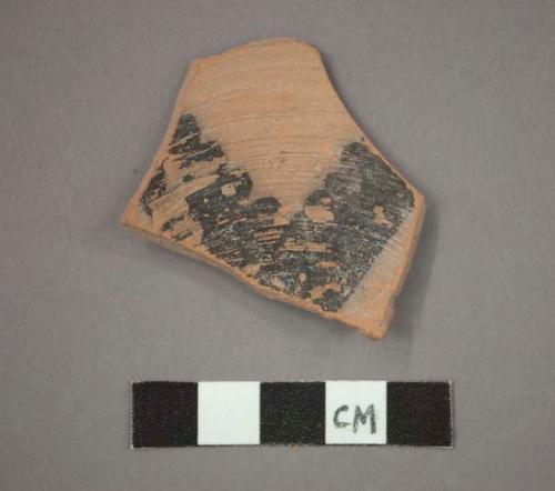 Ceramic base sherd, black painted design on interior