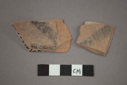 Ceramic base or body sherds with black painted design on interior
