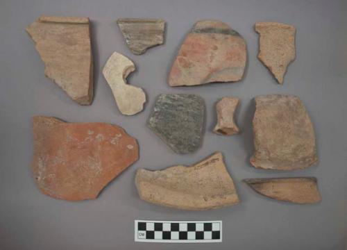 Ceramic sherds, some plain, some course, some burnished, some with painted design