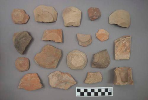 Ceramic base sherds, some with pigment or painted designs, one pedestal base