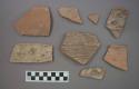 Ceramic rim or body sherds, one with incised designs, two with painted designs on exterior