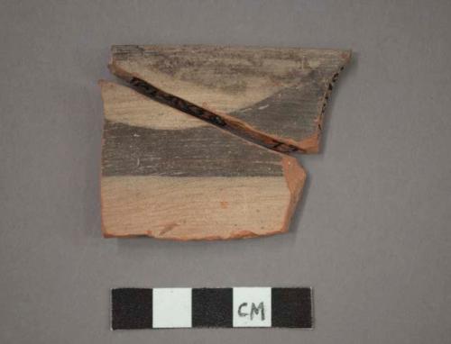 Ceramic rim sherd of bowl, red ware, black painted designs on buff, will mend together