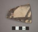 Ceramic body sherd, black designs on white on exterior