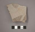 Ceramic base sherd, gray ware, red painted designs on interior