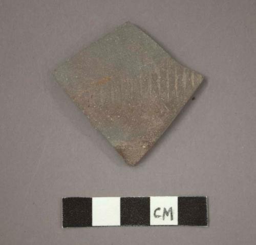 Ceramic body sherd, gray ware, band of incised parallel lines on exterior