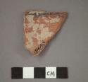 Ceramic rim sherd, black paint on rim edge, interior and exterior is red