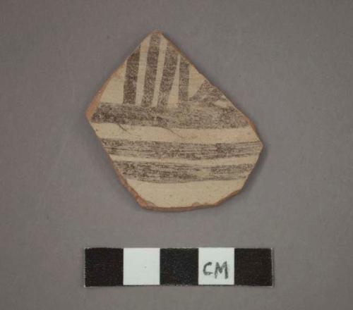 Ceramic body sherd, brown lines on buff on exterior